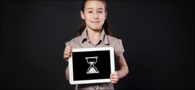 Young girl holding a tablet with a digital drawing of an hourglass on it. 