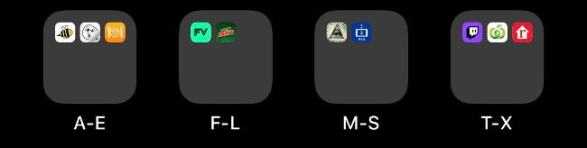 Four folders on an iOS Home screen labeled alphabetically.