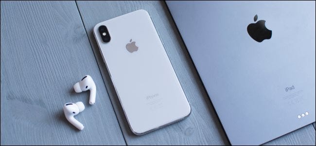 AirPods next to an iPhone and iPad
