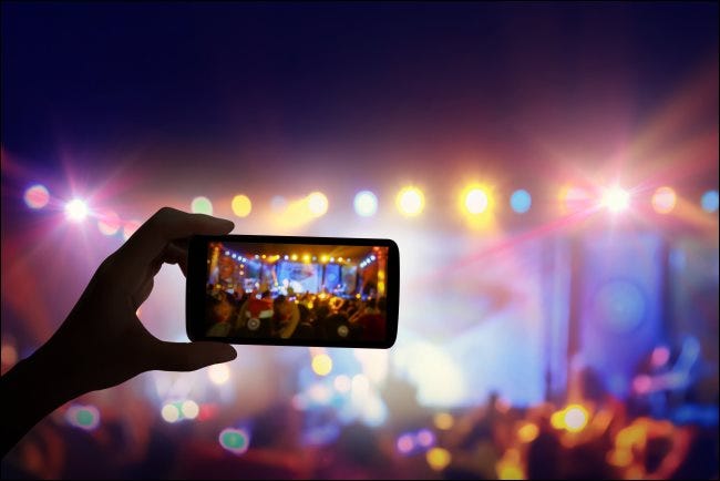 A smartphone recording a live concert.