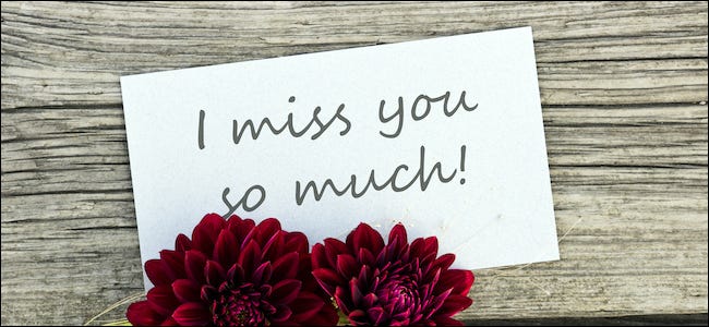 I miss you so much written on a sign next to flowers