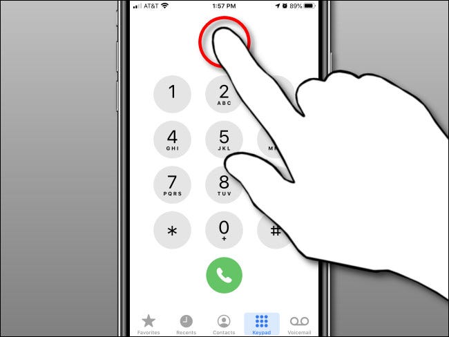 Tap and hold in the number display area, then release in the iPhone Phone app.