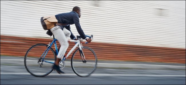 A man riding a bicycle on a city street.