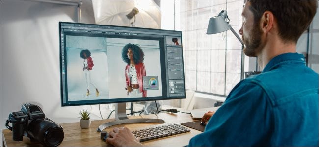 A professional photographer editing images in Photoshop.