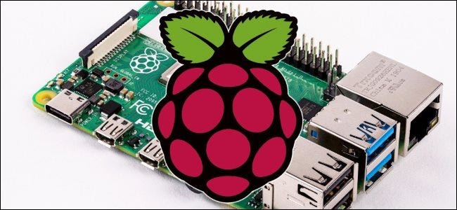 A Raspberry Pi and its official raspberry logo.