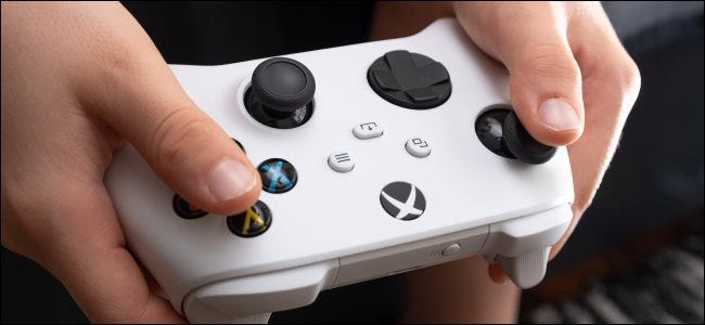 Someone holding an Xbox Series S controller.